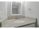Bathroom with white corner sink and vanity with speckled marble countertop at 5841 Bay Pines Lakes Blvd, St Petersburg, FL 33708
