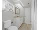 Bathroom with granite countertop vanity, updated toilet, and linen closet at 5841 Bay Pines Lakes Blvd, St Petersburg, FL 33708