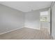 Bedroom with view to hallway; neutral paint and laminate flooring at 5841 Bay Pines Lakes Blvd, St Petersburg, FL 33708