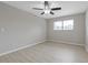 Bedroom featuring wood-look floors, ceiling fan, and bright window at 5841 Bay Pines Lakes Blvd, St Petersburg, FL 33708