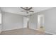 A well-lit bedroom shows the ceiling fan and a view of the staircase and the walk-in closet at 5841 Bay Pines Lakes Blvd, St Petersburg, FL 33708