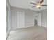 Bright bedroom featuring wood-look floors, ceiling fan, closet and sliding glass door at 5841 Bay Pines Lakes Blvd, St Petersburg, FL 33708