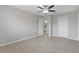 Bedroom featuring wood-look floors, ceiling fan, closet and ensuite bath at 5841 Bay Pines Lakes Blvd, St Petersburg, FL 33708