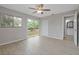 Bright bedroom featuring wood-look floors, ceiling fan, closet and sliding glass door to private deck at 5841 Bay Pines Lakes Blvd, St Petersburg, FL 33708
