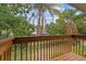 Wood deck overlooking lush backyard, perfect for enjoying the outdoors at 5841 Bay Pines Lakes Blvd, St Petersburg, FL 33708