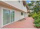 Inviting home exterior featuring a spacious wooden deck and sliding glass doors for seamless indoor-outdoor living at 5841 Bay Pines Lakes Blvd, St Petersburg, FL 33708