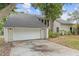 Attached two-car garage with a wide driveway, offering plenty of parking at 5841 Bay Pines Lakes Blvd, St Petersburg, FL 33708