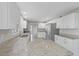 Well-lit kitchen with white cabinets, stainless appliances and granite counters, providing ample workspace at 5841 Bay Pines Lakes Blvd, St Petersburg, FL 33708