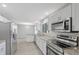 Modern kitchen with stainless steel appliances and white cabinets overlooking the dining room at 5841 Bay Pines Lakes Blvd, St Petersburg, FL 33708
