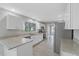 Bright kitchen with stainless steel appliances, granite countertops, and stylish white cabinets at 5841 Bay Pines Lakes Blvd, St Petersburg, FL 33708