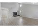 Spacious living room with a cozy fireplace, high ceilings, and plenty of natural light at 5841 Bay Pines Lakes Blvd, St Petersburg, FL 33708