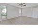 Living room with wood-look floors, bright windows, and neutral paint throughout at 5841 Bay Pines Lakes Blvd, St Petersburg, FL 33708
