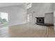 Bright living room with tall ceilings, a fireplace, and plenty of natural light from the window at 5841 Bay Pines Lakes Blvd, St Petersburg, FL 33708