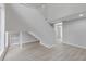 Spacious living room featuring light wood floors and an open staircase at 5841 Bay Pines Lakes Blvd, St Petersburg, FL 33708