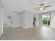Open-concept living area with sliding glass doors to the yard, modern flooring, and stairs to the next level at 5841 Bay Pines Lakes Blvd, St Petersburg, FL 33708