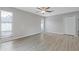 Large living room with wood floors, a ceiling fan, and lots of windows for natural lighting at 5841 Bay Pines Lakes Blvd, St Petersburg, FL 33708