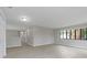 Large open space with wood-look floors, white trim, and a bright window that offers a view of the outdoors at 5841 Bay Pines Lakes Blvd, St Petersburg, FL 33708