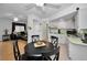 Open dining area showcases wood flooring and a living room view with black furniture at 7787 39Th N Ter # 7787, St Petersburg, FL 33709