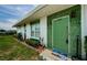 Inviting front entrance with a decorative green door and well-manicured landscaping at 7787 39Th N Ter # 7787, St Petersburg, FL 33709