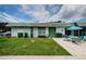 Inviting single-story home with a lush lawn and a charming outdoor seating area at 7787 39Th N Ter # 7787, St Petersburg, FL 33709