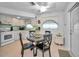 Cozy kitchen with white cabinets, modern appliances, and a dining area at 7787 39Th N Ter # 7787, St Petersburg, FL 33709