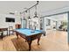 Entertain in this game room, complete with pool table and open view to kitchen at 1943 Jeffords St, Clearwater, FL 33764