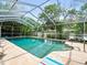 Screened-in pool with lounge chairs and brick pavers at 1943 Jeffords St, Clearwater, FL 33764