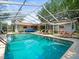 Large screened-in pool with plenty of lounge chairs at 1943 Jeffords St, Clearwater, FL 33764