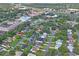 Aerial view of neighborhood, highlighting home's placement and nearby businesses at 7988 Ravenwood Cv, Spring Hill, FL 34606