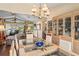 Bright dining room with glass table, chandelier, and built-in hutch at 7988 Ravenwood Cv, Spring Hill, FL 34606