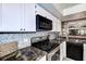 Close-up of kitchen stovetop and hexagonal backsplash at 2599 Dolly Bay Dr # 308, Palm Harbor, FL 34684