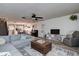 Open living room with L-shaped sofa and large TV at 2599 Dolly Bay Dr # 308, Palm Harbor, FL 34684