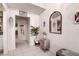Bright condo entryway with mirror, small table, and coat rack at 2599 Dolly Bay Dr # 308, Palm Harbor, FL 34684