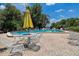 Community pool with patio furniture and lake views at 2599 Dolly Bay Dr # 308, Palm Harbor, FL 34684
