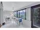Sunroom with tiled floor, seating area, and access to patio at 19029 Us Highway 19 N # 12B, Clearwater, FL 33764