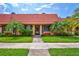 Exterior view of a charming condo with landscaping at 19029 Us Highway 19 N # 12B, Clearwater, FL 33764