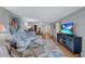 Spacious living room with sectional sofa, hardwood floors, and TV at 19029 Us Highway 19 N # 12B, Clearwater, FL 33764
