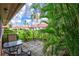 Private patio with table and chairs, overlooking lush landscaping at 19029 Us Highway 19 N # 12B, Clearwater, FL 33764