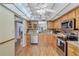 Bright kitchen with oak cabinets, stainless steel appliances, and wood flooring at 19029 Us Highway 19 N # 12B, Clearwater, FL 33764