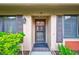 Tan colored house with brown shutters and a screened door at 19029 Us Highway 19 N # 12B, Clearwater, FL 33764