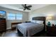 Comfortable bedroom with a ceiling fan, large windows, and a dresser at 10216 Regal Dr # 708, Largo, FL 33774