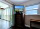 Bedroom with a dresser, large windows, and access to a balcony at 10216 Regal Dr # 708, Largo, FL 33774