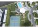 Aerial view of community pool, tennis courts, and surrounding landscape at 10216 Regal Dr # 708, Largo, FL 33774