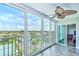 Sunroom with tiled floors, ceiling fan, and sliding doors showcasing a beautiful view at 10216 Regal Dr # 708, Largo, FL 33774