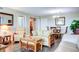 Living room with hardwood floors, comfortable seating and a view into the dining area at 10216 Regal Dr # 708, Largo, FL 33774