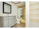 Bathroom with yellow tiled shower and gray vanity at 10216 Regal Dr # 708, Largo, FL 33774