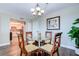 Dining area with wood floors, chandelier and view of living room at 10216 Regal Dr # 708, Largo, FL 33774
