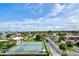 Aerial view of two tennis courts, parking lot and residential buildings at 10216 Regal Dr # 708, Largo, FL 33774