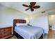 Bright bedroom featuring a ceiling fan and wicker furniture at 10216 Regal Dr # 708, Largo, FL 33774