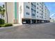 Building exterior showcasing covered parking and landscaping at 10216 Regal Dr # 708, Largo, FL 33774